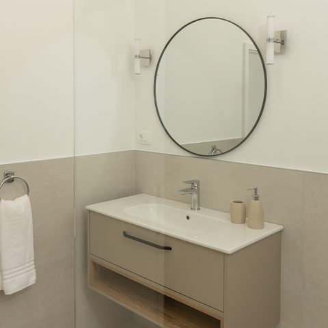 Bathroom vanity with round mirror
