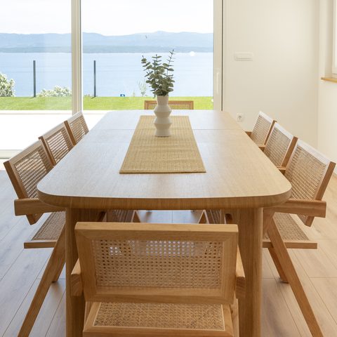 Oak dining table with seating for eight and sea view